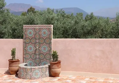 a decorative pillar with two potted plants on a wall at villa saada in Marrakech
