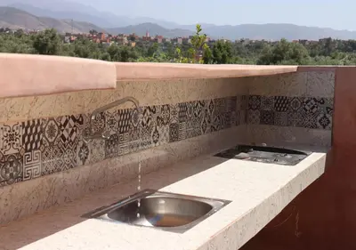 a kitchen with a sink in a stone counter top at villa saada in Marrakech