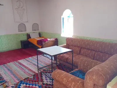 a living room with a couch and a table at Grotte Salwa in Aït Ben Haddou