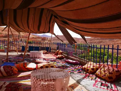 a tent with a lot of stuff on the ground at Grotte Salwa in Aït Ben Haddou