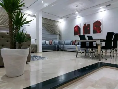 a living room with a couch and a table and chairs at B&B DELUXE COMFORT in Fès