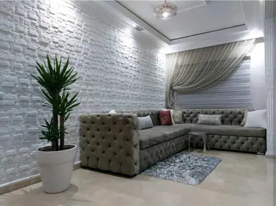 a living room with a couch and a plant at B&B DELUXE COMFORT in Fès