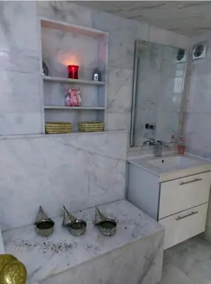 a bathroom with a sink and a mirror at B&B DELUXE COMFORT in Fès