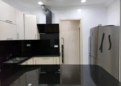 a kitchen with a black counter top and a refrigerator at B&B DELUXE COMFORT in Fès