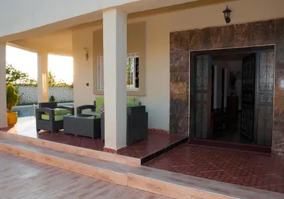a living room with a large door in a house at Vila Haja - Beautiful Farmhouse with a Private Pool! in Imouzzer Kandar