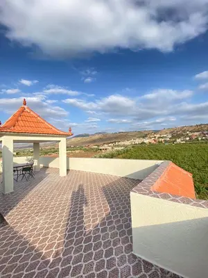 a patio with a gazebo and a table at Vila Haja - Beautiful Farmhouse with a Private Pool! in Imouzzer Kandar
