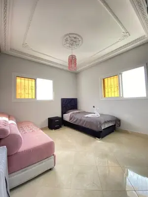 a bedroom with two beds and a ceiling with windows at Vila Haja - Beautiful Farmhouse with a Private Pool! in Imouzzer Kandar