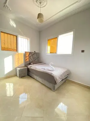 a bedroom with a bed in a room with windows at Vila Haja - Beautiful Farmhouse with a Private Pool! in Imouzzer Kandar