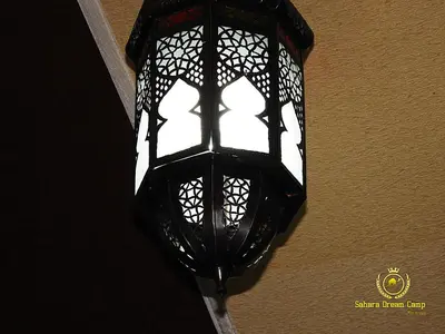 a black street light hanging on a wall at Luxury Desert Camp in Merzouga in Tisserdmine