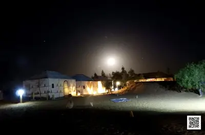a night time view of a skateboard ramp in front of a building at Luxury Desert Camp in Merzouga in Tisserdmine