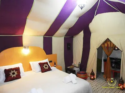 a bedroom with a bed and a tent at Luxury Desert Camp in Merzouga in Tisserdmine