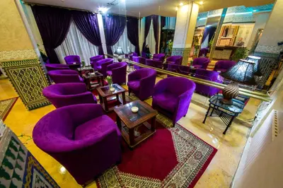 an overhead view of a room with purple chairs and tables at Hotel Akouas in Meknès