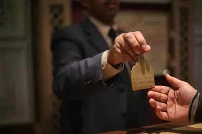 a person holding a tag in their hand at Hotel Akouas in Meknès