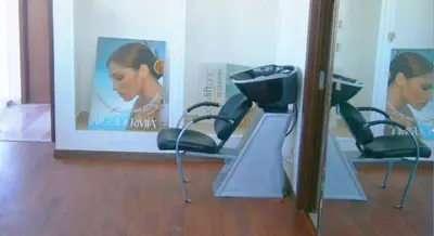 a hair salon with three chairs and a mirror at Hotel Angle Atlas & Spa in Tit n Ziza
