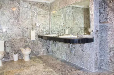 a bathroom with two sinks and a toilet at Hotel Angle Atlas & Spa in Tit n Ziza