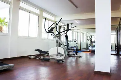 a gym with several tread machines in a room at Hotel Angle Atlas & Spa in Tit n Ziza