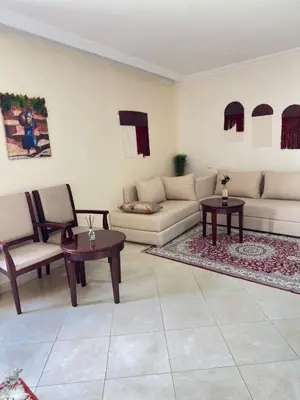 a living room with a couch and chairs and tables at Hotel Angle Atlas & Spa in Tit n Ziza