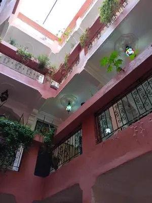 a building with a balcony with plants on it at Riad dar Ahlam in Aït Baha