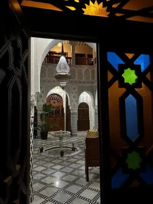 a view of a courtyard with a fountain in a building at Riad Palais Marouane in Meknès