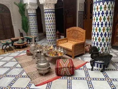 a room with a table and a couch in a room at Riad Palais Marouane in Meknès