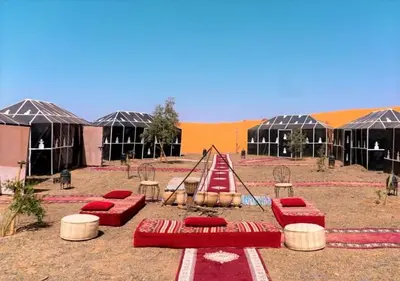 a playground with red chairs and a swing at Desert Life Camp in Merzouga