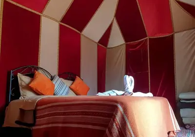 a room with a bed in a tent at Desert Life Camp in Merzouga