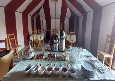 a table with plates and bowls of food on it at Desert Life Camp in Merzouga