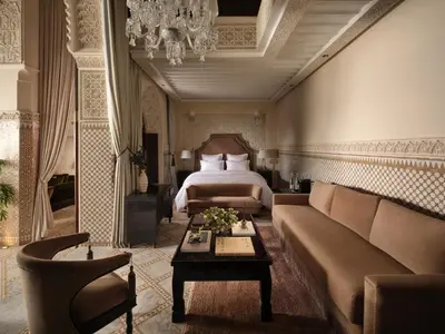 a living room with a couch and a bed at Palais De Fès Suites & Spa in Fès