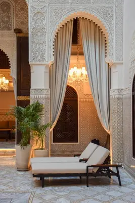 a living room with a couch and a curtain at Palais De Fès Suites & Spa in Fès