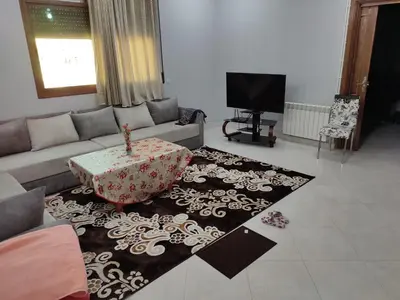 a living room with a couch and a table on a rug at The good stay 2 midelt in Midelt