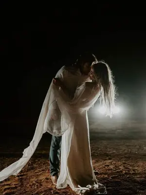 a man and a woman hugging each other at Aladdin merzouga camp in Merzouga