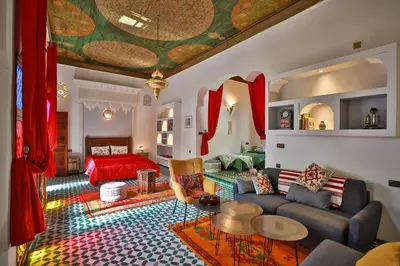 a living room with a couch and a table at Riad Le Moucharabieh in Fès