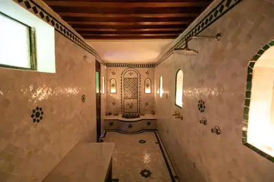 a hallway of a house with a tile wall at Riad Le Moucharabieh in Fès