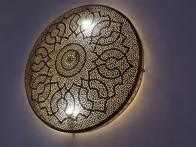 a black egg with a white design on a wall at Riad Le Moucharabieh in Fès