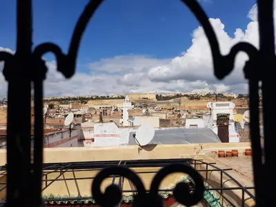 a view of a city from a window at Riad Le Moucharabieh in Fès