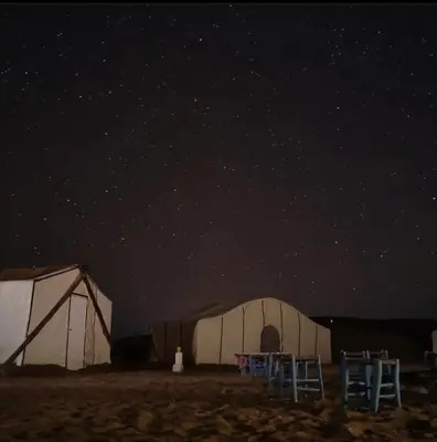 a couple of tents in a field at night at Bivouac ZAGORA in Zagora