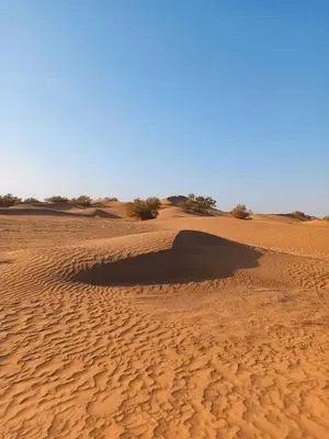 a hole in the sand in the desert at Nomadic Stay in Mhamid