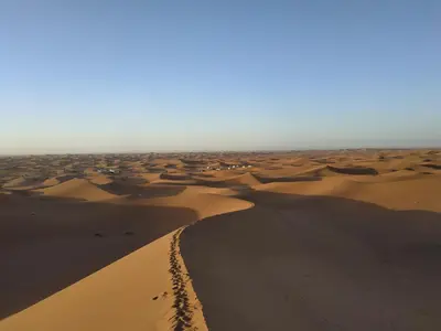 a view of a desert with footprints in the sand at Bivouac Le charme d'Aladdin in El Gouera