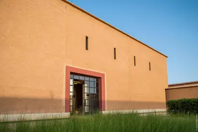 a large orange building with a door in it at Côté Sud in Ouarzazate