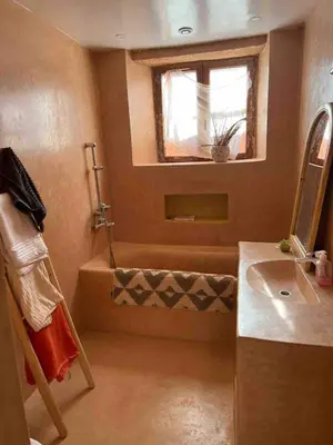 a bathroom with a shower and a sink and a window at Berberbayt lodge maison privé in Tinerhir