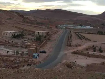 a winding road in the middle of a desert at Berberbayt lodge maison privé in Tinerhir