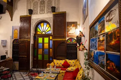 a room with a couch and a stained glass door at Dar Lalamoune in Fès