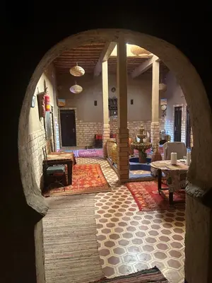 an archway in a building with a living room at kasbah planet sahara in Merzouga