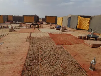a room with a large rug on the ground at Erg Chegaga Camp & Activites in Mhamid