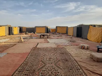 a view of a mosque with a rug on the floor at Erg Chegaga Camp & Activites in Mhamid