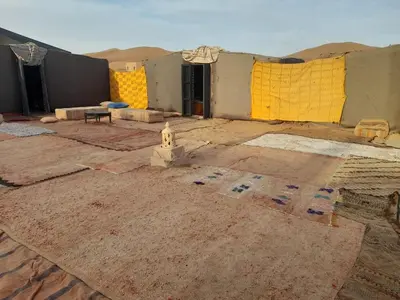 a building under construction in the middle of the desert at Erg Chegaga Camp & Activites in Mhamid