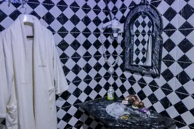 a bathroom with a sink and a mirror at Salma Palms Hôtel in Madkhal Meski