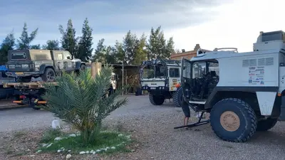 a group of military trucks parked in a lot at Salma Palms Hôtel in Madkhal Meski