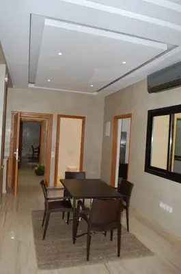 a dining room with a table and chairs at Suites Appartement Midelt in Midelt