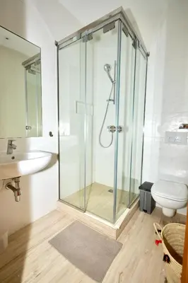 a bathroom with a shower and a toilet and a sink at Suites Appartement Midelt in Midelt